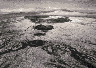 Mauna Loa Volcano, Hawaii, a giant among the active volcanoes of the world; snow-capped Mauna Kea Volcano in the distance. SOURCE: U.S. Geological Survey